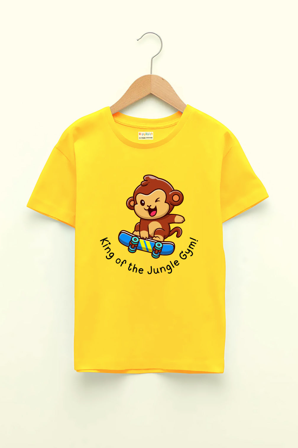 A yellow round neck T-shirt with a print of a monkey on a skateboard and the text 'King of the Jungle gym'